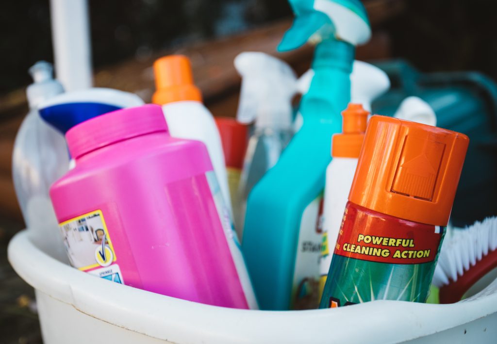 Basket filled with various cleaning bottles and sprays